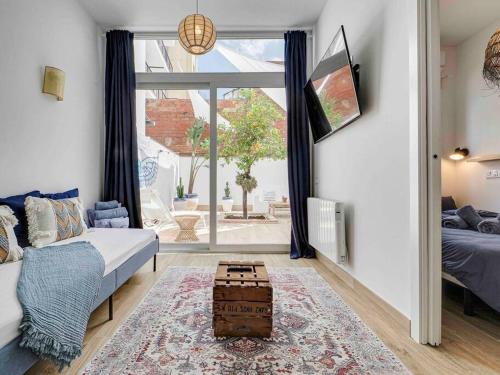 uma sala de estar com um sofá e uma mesa em Casa Mandarina: 4 Bedrooms - 2 Terraces - Parking em Hospitalet de Llobregat