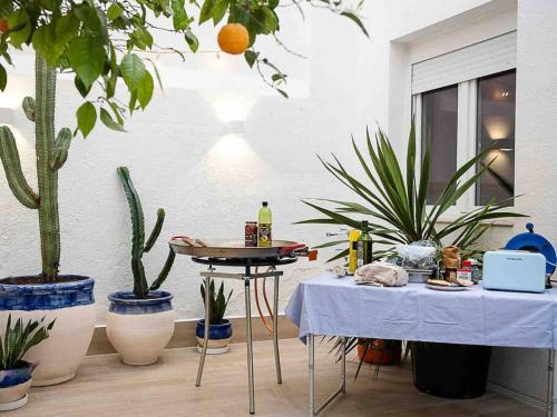 a room with two tables and potted plants at Casa Mandarina: 4 Bedrooms - 2 Terraces - Parking in Hospitalet de Llobregat
