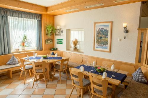 a dining room with wooden tables and chairs at Landgasthof Weberhans in Harburg