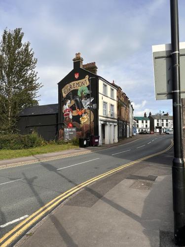 a building with a mural on the side of it on a street at Victoria in Egremont