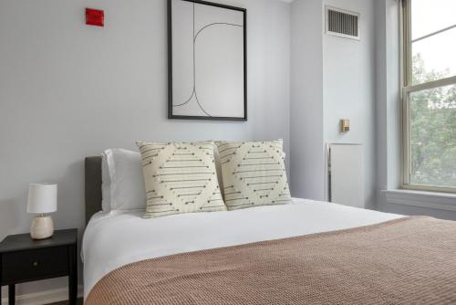 a bedroom with a bed with a mirror on the wall at Central Square 2br w in-unit wd nr restaurants BOS-898 in Cambridge