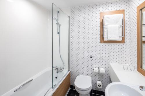a bathroom with a toilet and a sink and a shower at Holiday Inn London - Gatwick Airport by IHG in Horley