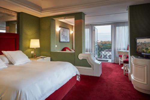 a hotel room with a large bed and a large window at Hotel Lord Byron - Small Luxury Hotels of the World in Rome