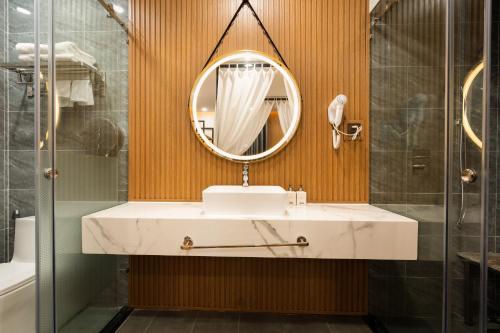 a bathroom with a sink and a mirror at MICASA HOTEL in Ho Chi Minh City