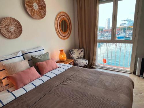 a bedroom with a large bed and a large window at Marinca du Port de Toulon in Toulon