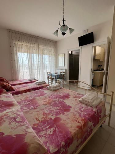 a bedroom with a large bed with a purple blanket at Le Stanze di Lucia vicino Ospedale Cardinale Panico a Tricase in Tricase