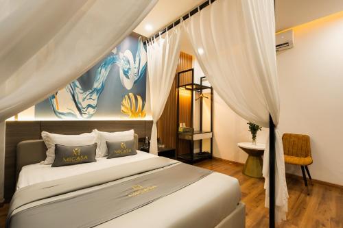 a bedroom with a large bed with a canopy at MICASA HOTEL in Ho Chi Minh City