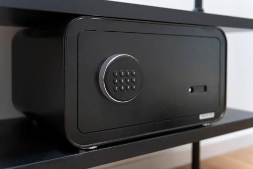 a black microwave oven sitting on a shelf at The Barthels Boutique Hotel in Würzburg