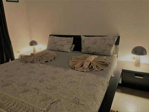 a bed in a bedroom with two pillows on it at Villa Rada, Bay View Villas in Kosharitsa