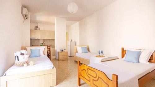 a bedroom with two beds with white and blue pillows at Stylish Extra - BIG 1+1 Central Apt in Himare