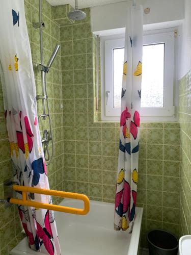 a bathroom with a shower with a shower curtain at Birgeler Home in Birgel