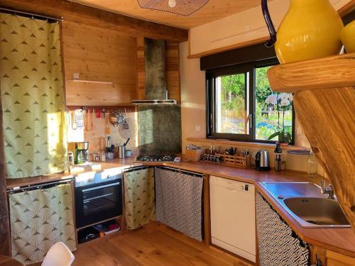 a kitchen with a sink and a counter top at La Petite Maison du hÊtre in Brassac