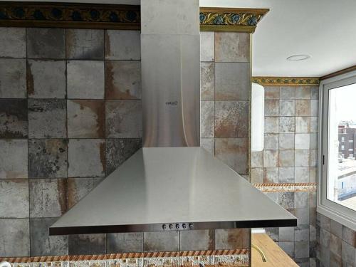 a stainless steel stove top oven in a kitchen at Luxury art Apartamenty in Pineda de Mar