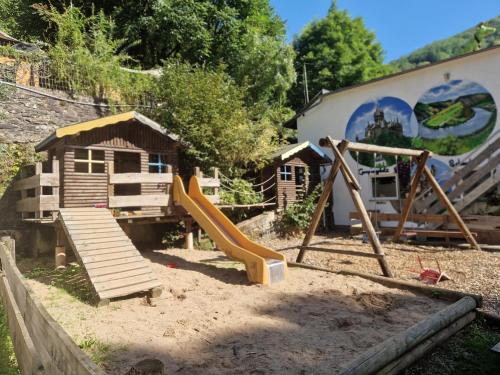 a playground with a slide and a house at Dachzelt Cochem in Cochem