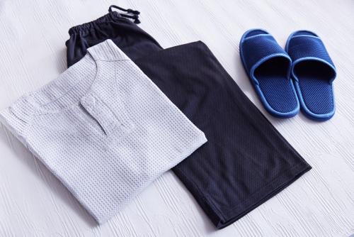 a pair of blue shoes and a pair of shorts and a black bag at サザンシティホテル in Nankoku