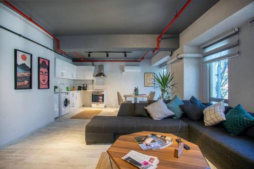 a living room with a couch and a table at Luxury Loft Flat 5 mins away by the Sea /Nr:2 in Istanbul