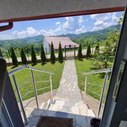 an open door with a view of a house at Vidikovac pod Jelicom in Čačak