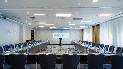 a large meeting room with a long table and chairs at Park Inn by Radisson Hotel Astana in Astana