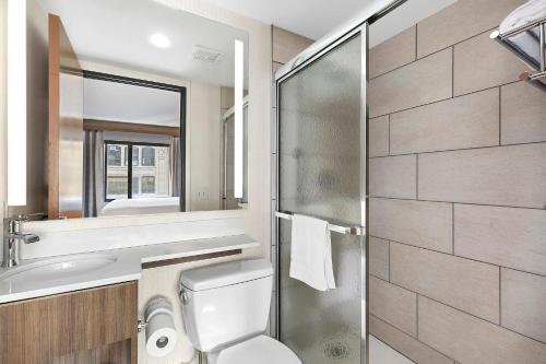 a bathroom with a toilet and a sink and a shower at Holiday Inn Manhattan 6th Ave - Chelsea, an IHG Hotel in New York