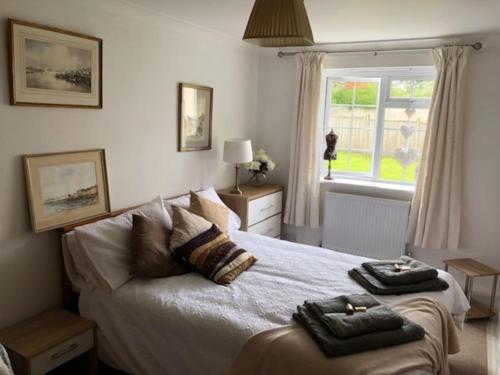 a bedroom with a bed with two towels on it at Carbis Bay luxury ground floor flat close to beach in Carbis Bay
