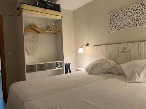 a bedroom with a large white bed with a headboard at Aljara Corredera in Córdoba