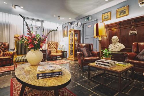 - un salon avec une statue, une table et des chaises dans l'établissement 2GO4 Quality Hostel Brussels Grand Place, à Bruxelles
