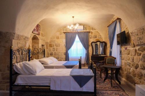 馬爾丁的住宿－MİRSTONE TARİHİ KONAK，一间卧室设有两张床和窗户。