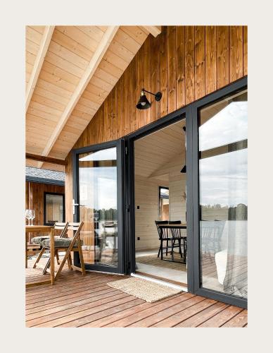 a screened in porch with sliding glass doors at Port Sztynort in Węgorzewo