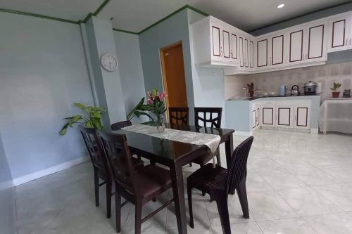 a kitchen and dining room with a table and chairs at La Residencia Tacloban in Tacloban