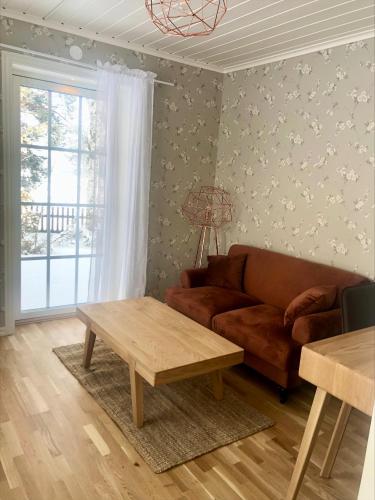 a living room with a couch and a table at Orbaden Spa & Resort in Vallsta