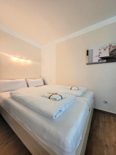 2 camas en una habitación con sábanas blancas en Winterberg Appartement 21115, en Winterberg