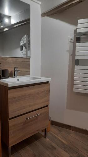 a bathroom with a sink and a mirror at L'Ostal de Gagnac in Gagnac-sur-Cère