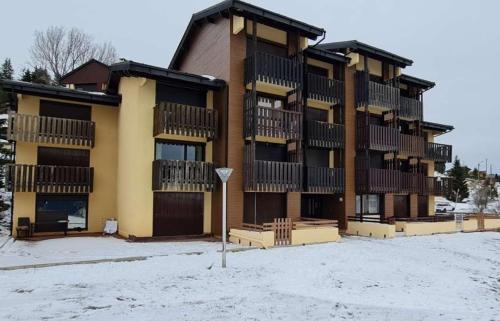 a large apartment building with snow in front of it at Studio 4 personnes in Font Romeu Odeillo Via