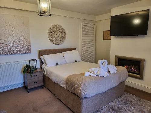 a bedroom with a bed and a tv on the wall at Seaside Flat with Fast WiFi in Scarborough