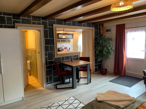 a living room with a table and a chair at Moselina Gästezimmer in Sankt Aldegund