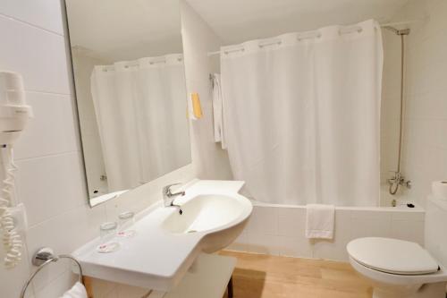 a white bathroom with a sink and a toilet at JS Ca'n Picafort in Can Picafort