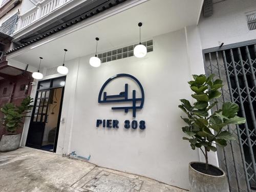 a white building with a sign on the side of it at PIER 808 Hostel in Bangkok