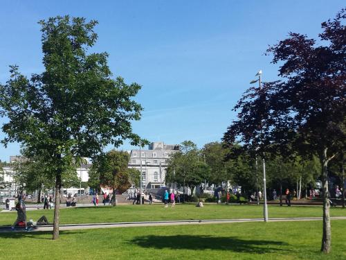 people in a park with a building in the background at Flannery's Hotel in Galway