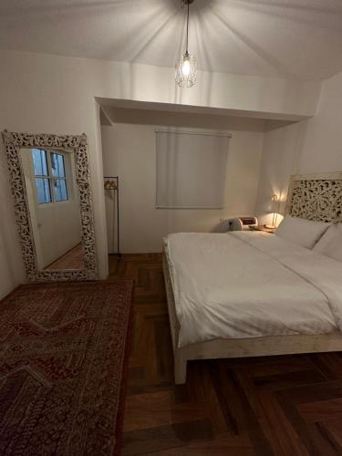 a bedroom with a bed and a mirror and a window at Dar Sayang in Taif