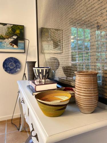 a table with bowls and baskets on top of it at 1 Royal Street Guesthouse in Riebeek-Kasteel