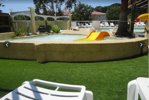 a small pool with a playground with a slide at Mobilhome au nom de Medouze (à annoncer à l'accueil du camping) in Fréjus