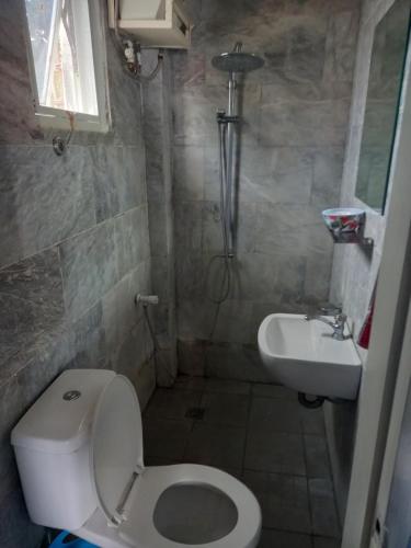 a small bathroom with a toilet and a sink at Germaroze in Oslob