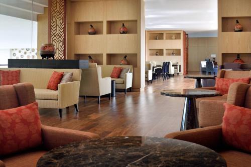 a lobby with couches and tables and chairs at Kigali Marriott Hotel in Kigali