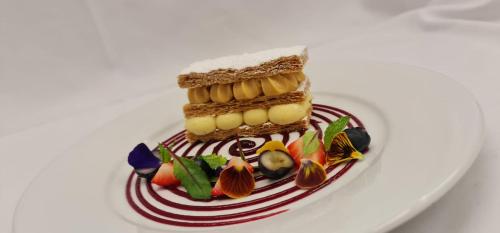 a white plate with a piece of cake on it at Crowne Plaza Reading in Reading