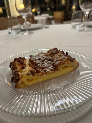 a slice of pizza on a plate on a table at Hostal de la Plaça - Hotel Boutique in Cabrils
