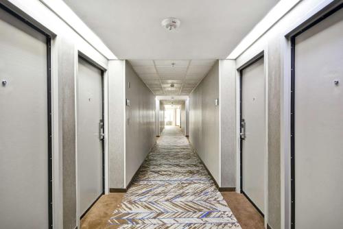 a corridor of an office building with a hallway at Hampton Inn Detroit Madison Heights South Troy in Madison Heights