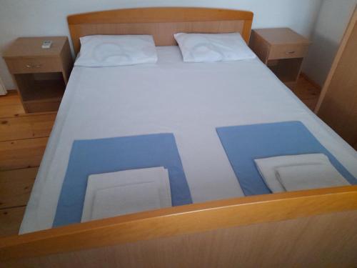 a bed with blue squares on it in a room at Anita Guest House in Tivat
