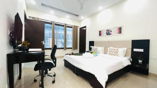 a bedroom with a desk and a bed and a desk at BluO 1BHK - DLF CyberCity, Balcony, Lift, Parking in Gurgaon