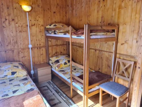 a room with two bunk beds and a chair at Cozy holiday homes near the beach in Jaros awiec in Jarosławiec