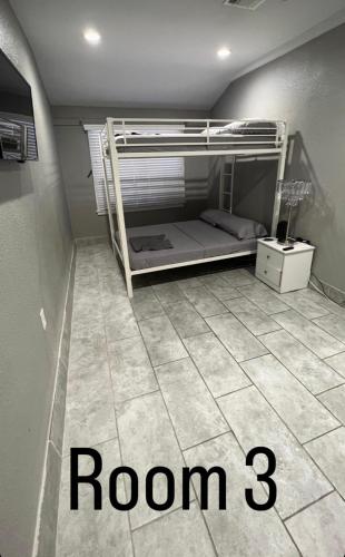 a bedroom with a bunk bed with a room at Charming and Cozy Place in Las Vegas